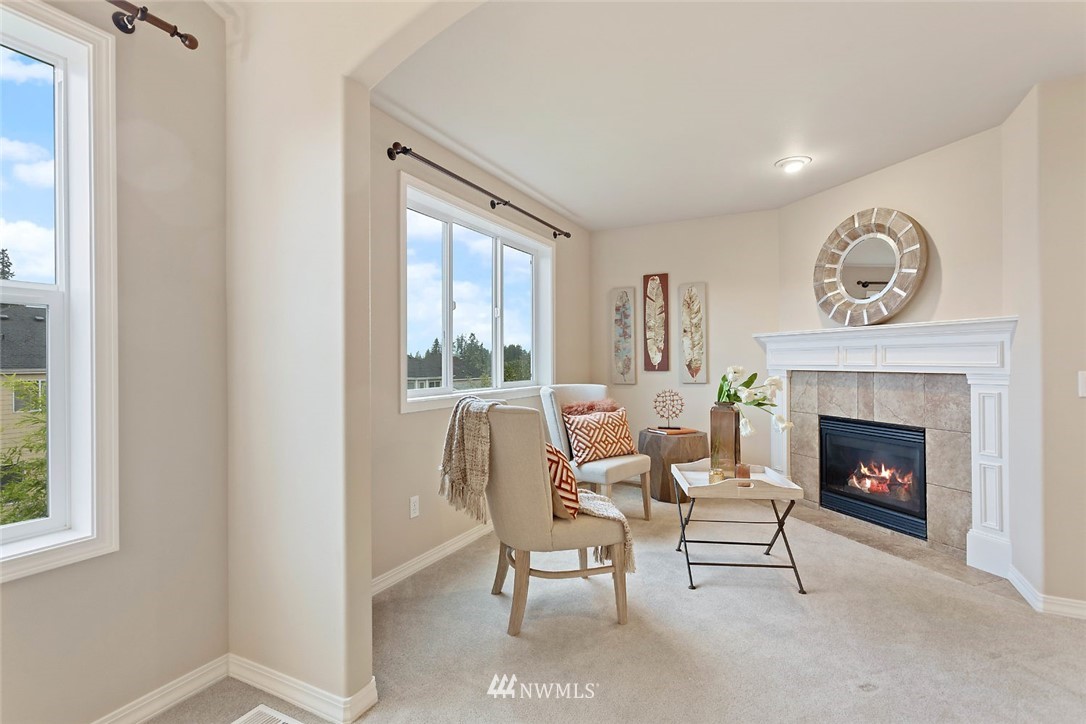 4124 215th Street Southeast Bothell, WA 98021 - Photo 12 of 30 a living room with furniture and a fireplace