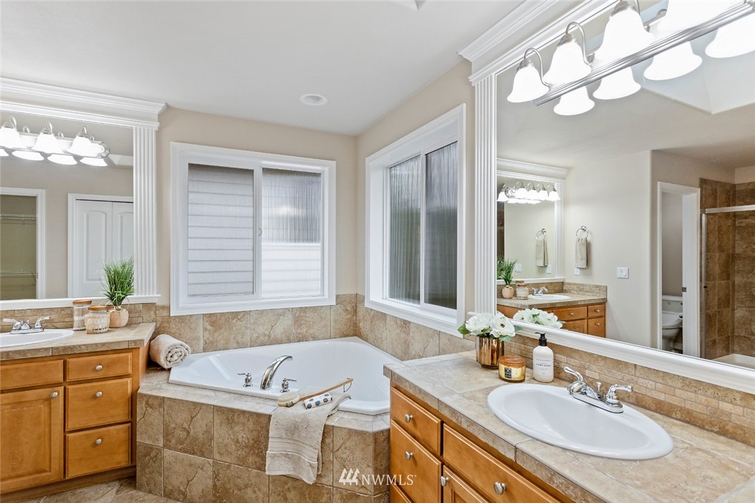 4124 215th Street Southeast Bothell, WA 98021 - Photo 14 of 30 a bathroom with a granite countertop tub sink and mirror