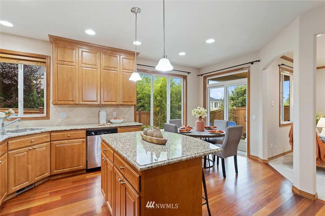 4124 215th Street Southeast Bothell, WA 98021 - Photo 3 of 30 a open kitchen with a table chairs and wooden floor