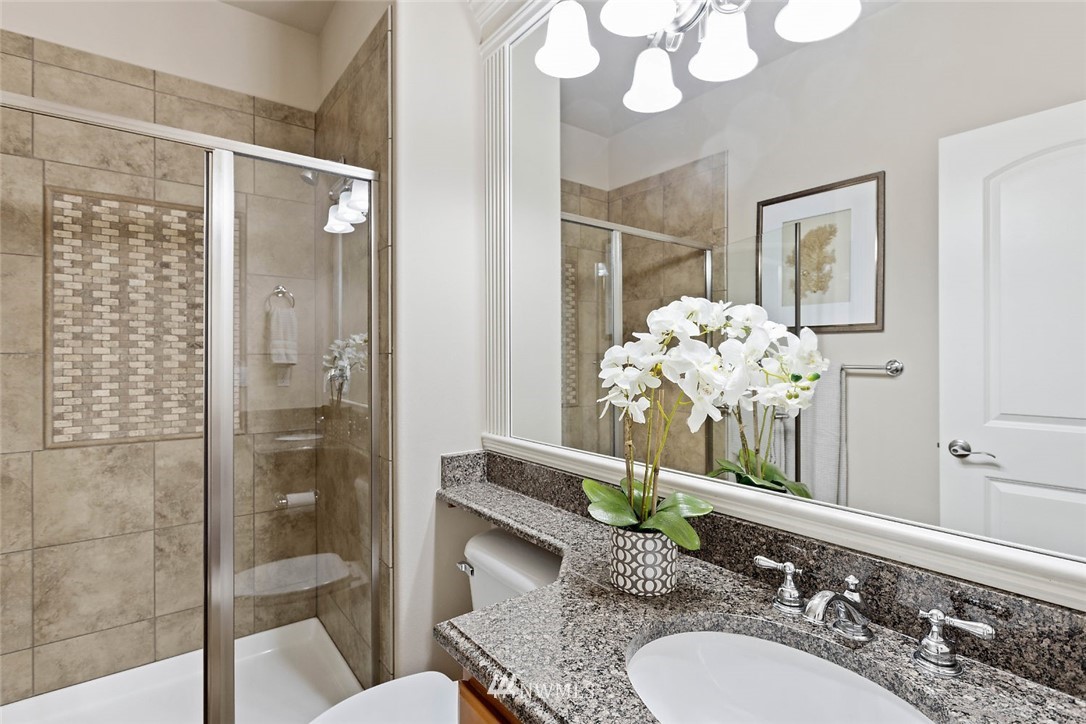 4124 215th Street Southeast Bothell, WA 98021 - Photo 23 of 30 a bathroom with a granite countertop sink and a mirror