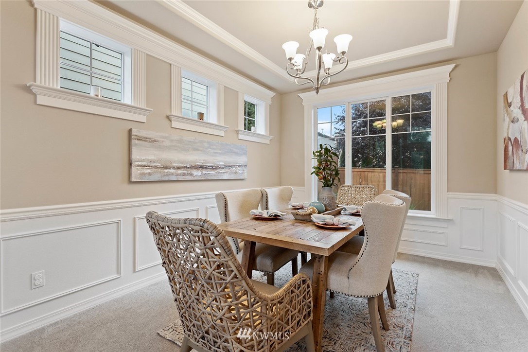 4124 215th Street Southeast Bothell, WA 98021 - Photo 25 of 30 a dining room with furniture a chandelier and wooden floor