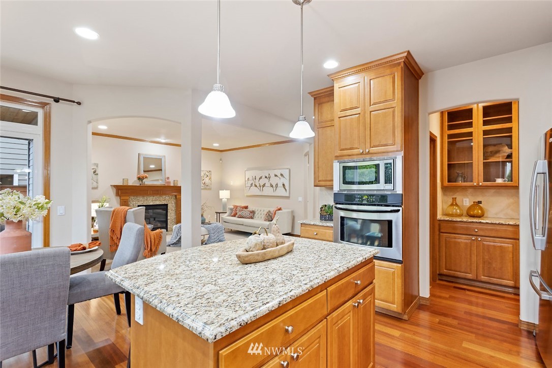 4124 215th Street Southeast Bothell, WA 98021 - Photo 4 of 30 a kitchen with stainless steel appliances granite countertop a sink refrigerator and cabinets