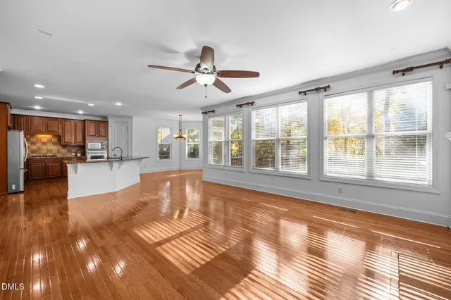 a kitchen with stainless steel appliances a stove top oven a sink and a refrigerator