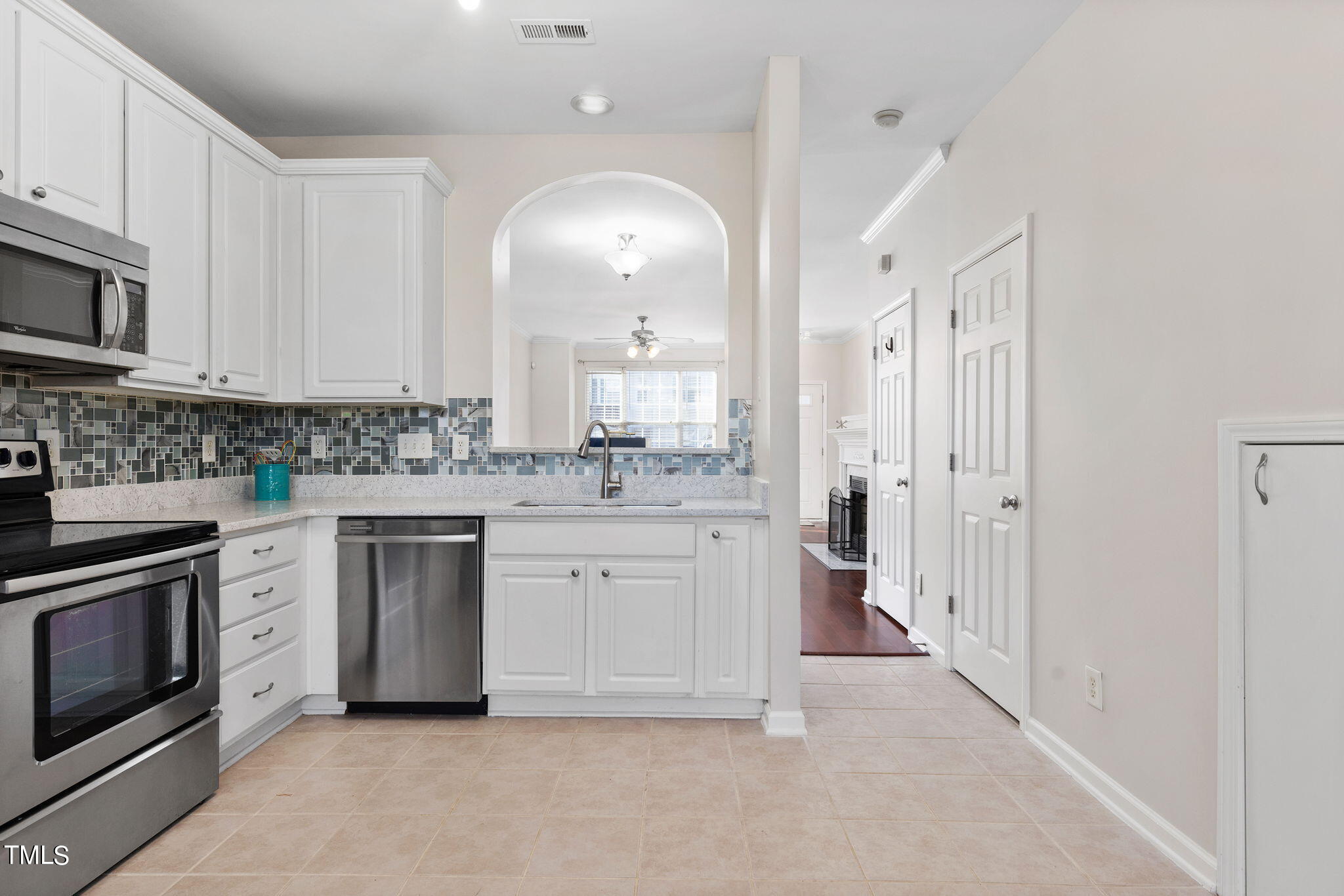 8330 City Loft Court Raleigh, NC 27613 - Photo 11 of 23 a kitchen with white cabinets and stainless steel appliances