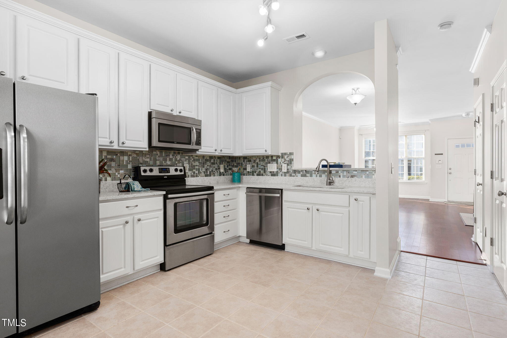 8330 City Loft Court Raleigh, NC 27613 - Photo 12 of 23 a kitchen with white cabinets and stainless steel appliances
