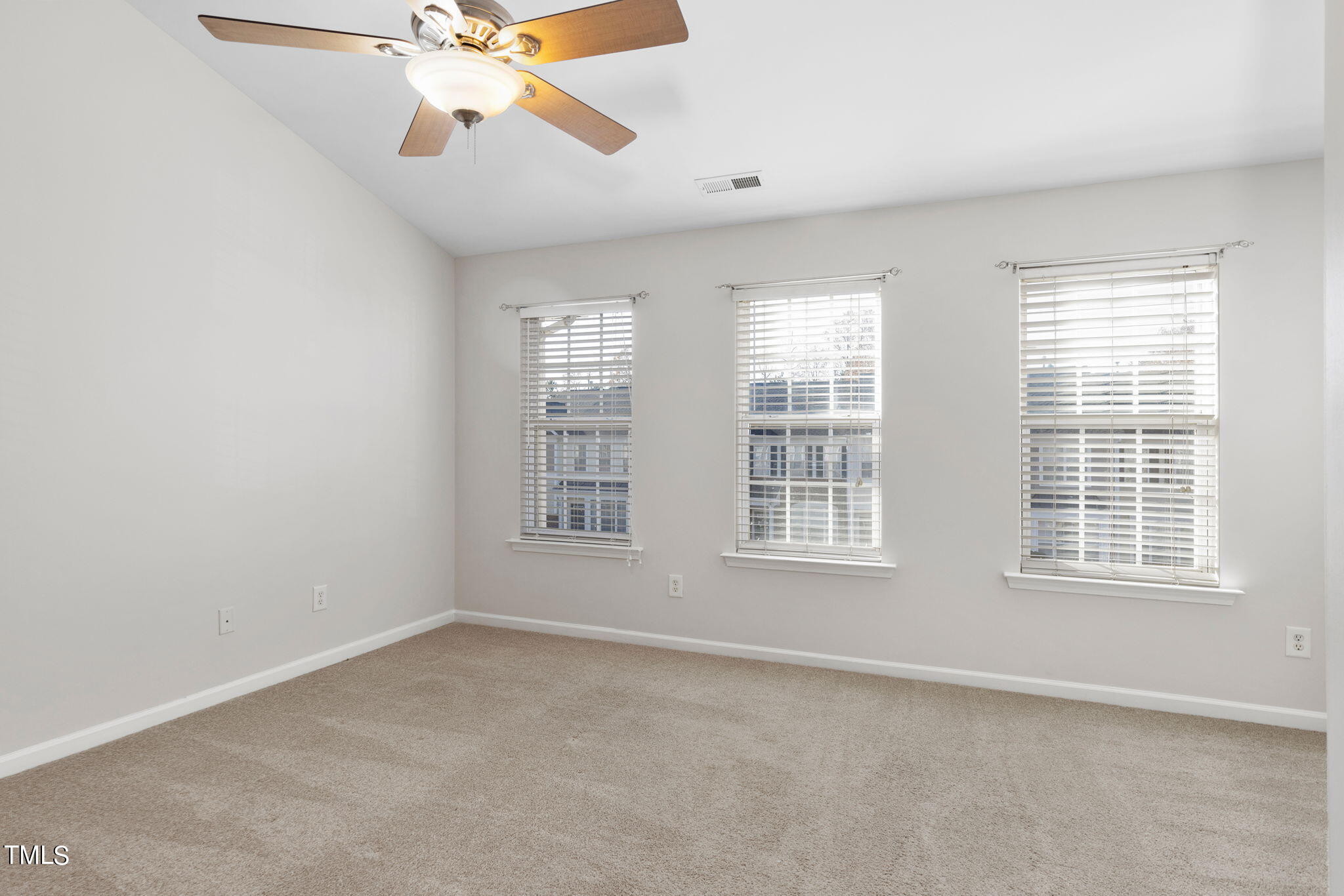 8330 City Loft Court Raleigh, NC 27613 - Photo 13 of 23 an empty room with chandelier fan and windows