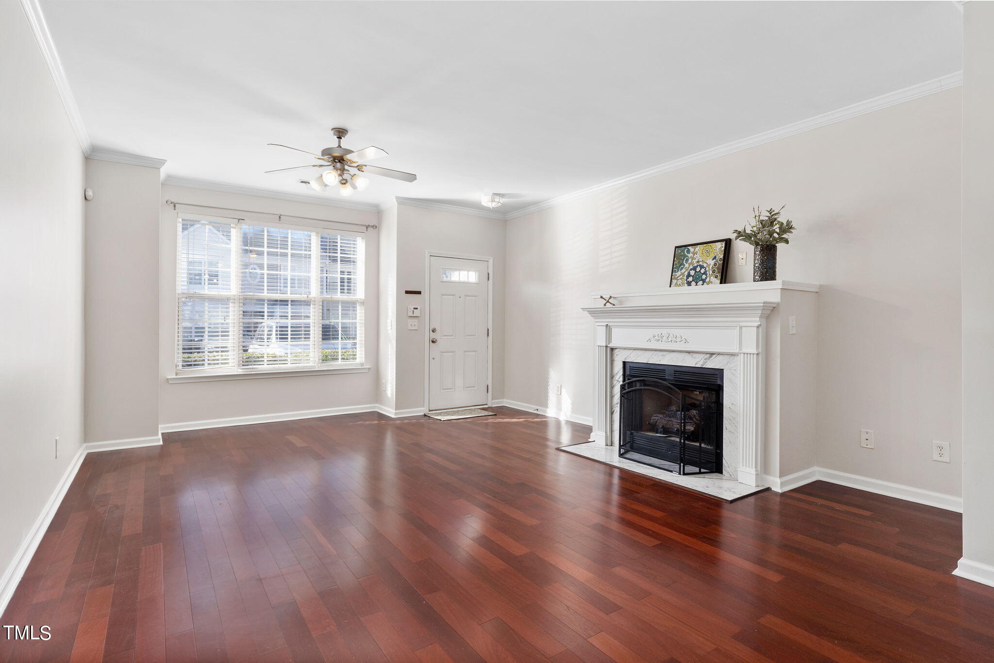 8330 City Loft Court Raleigh, NC 27613 - Photo 5 of 23 a view of an empty room with wooden floor fireplace and a window