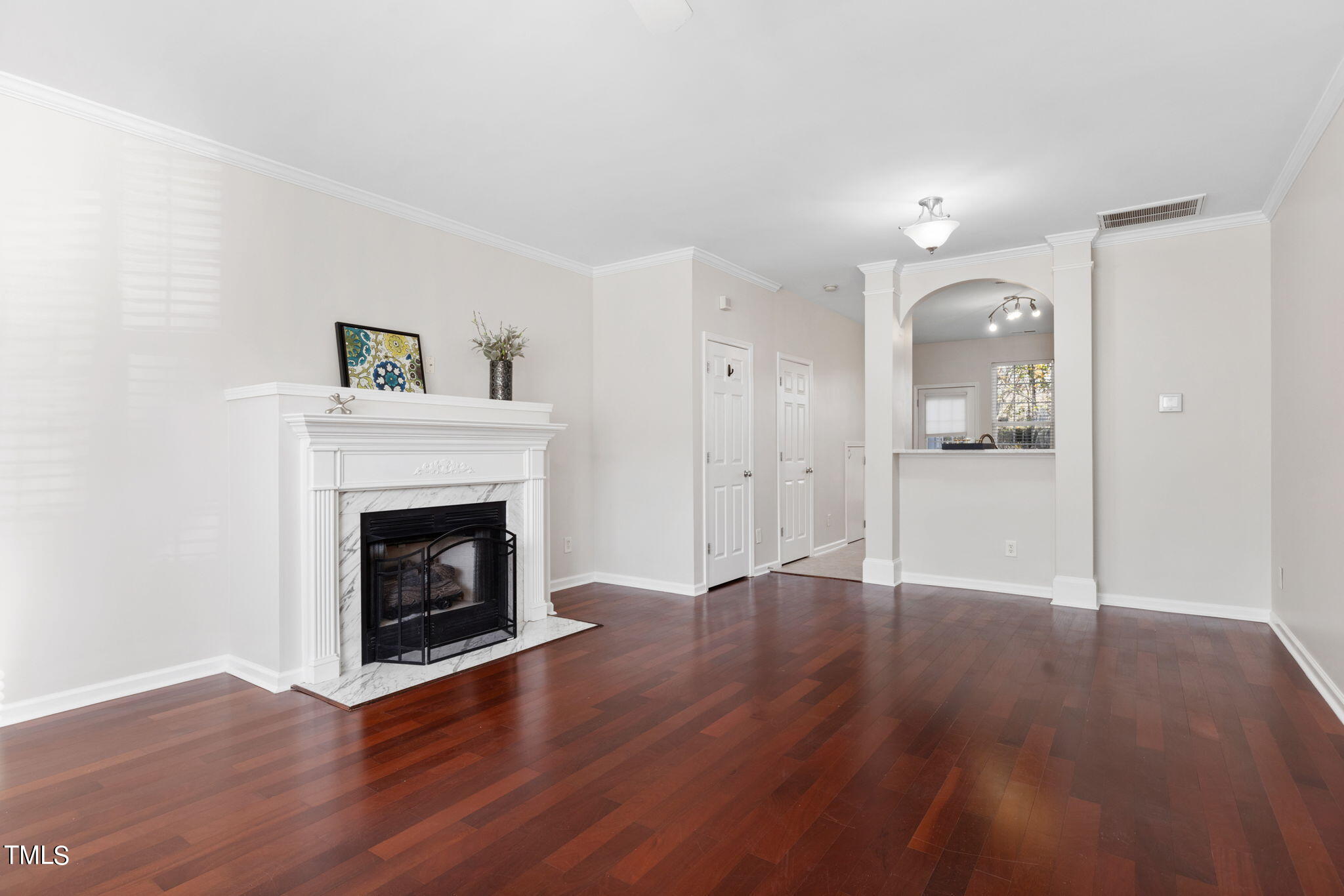 8330 City Loft Court Raleigh, NC 27613 - Photo 6 of 23 a view of an empty room with wooden floor fireplace and a window