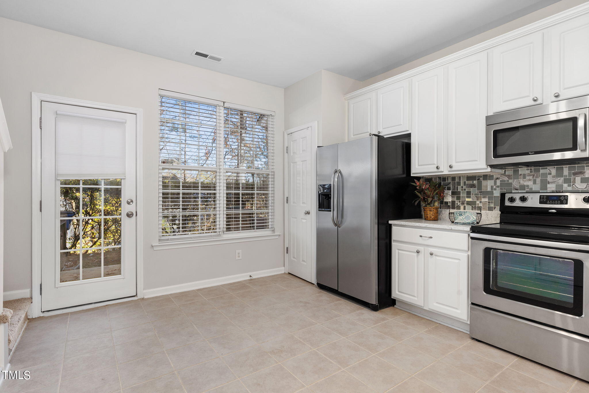8330 City Loft Court Raleigh, NC 27613 - Photo 8 of 23 a kitchen with stainless steel appliances a refrigerator stove and microwave