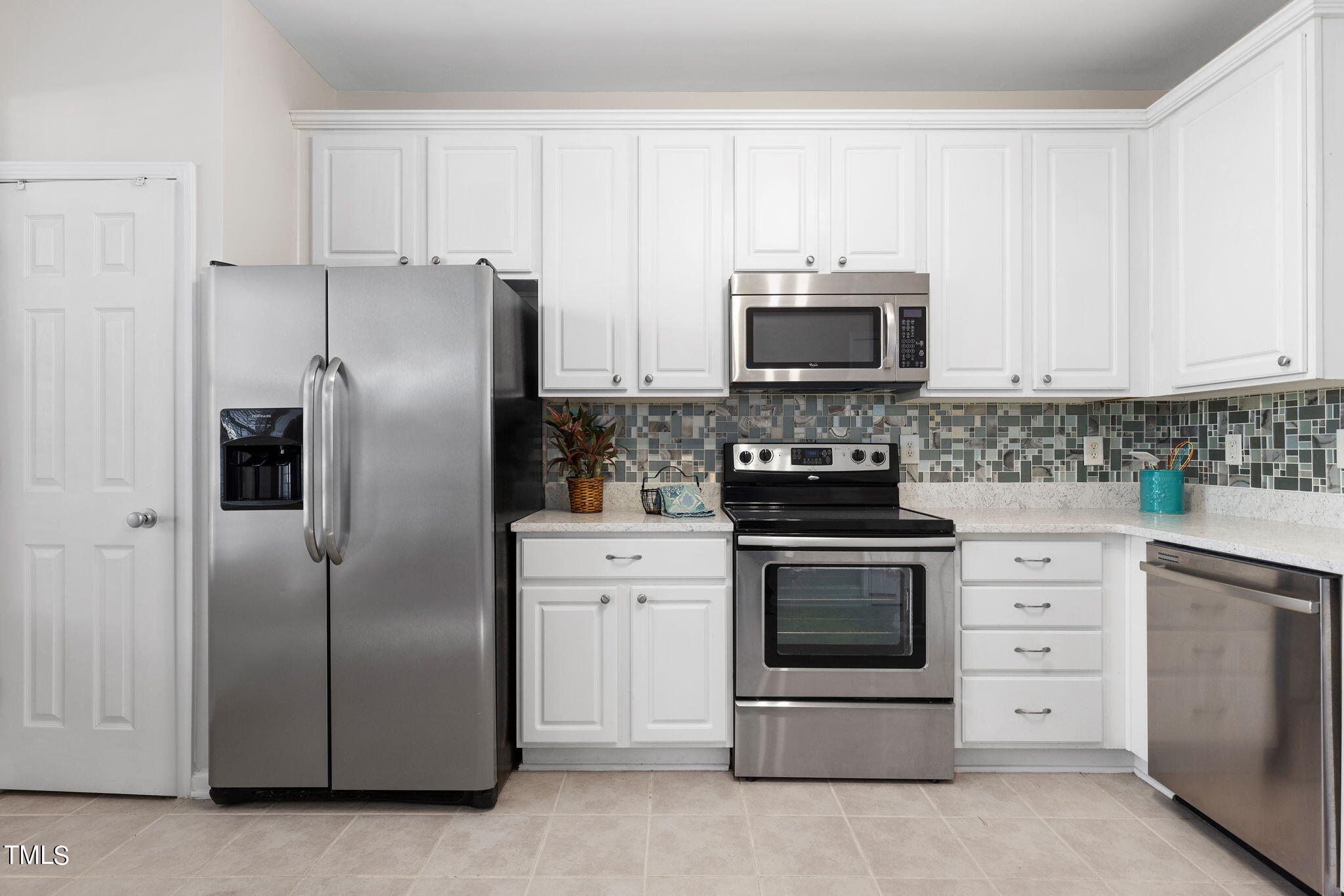 8330 City Loft Court Raleigh, NC 27613 - Photo 9 of 23 a kitchen with cabinets stainless steel appliances and a counter space