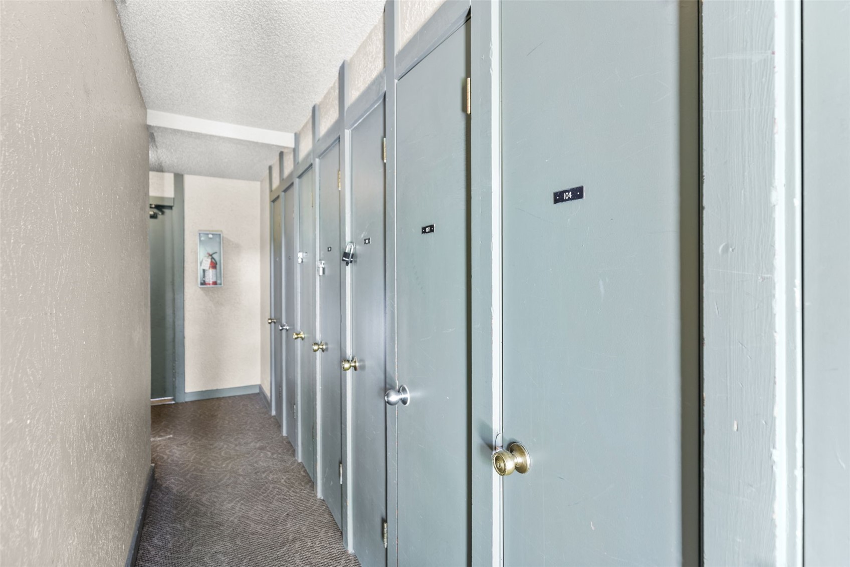 1127 Ski Hill Road, Unit 104 Breckenridge, CO 80424 - Photo 25 of 32 a view of a hallway with closet and wooden door