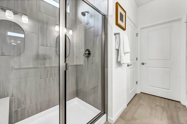 a bathroom with a glass shower door and a sink