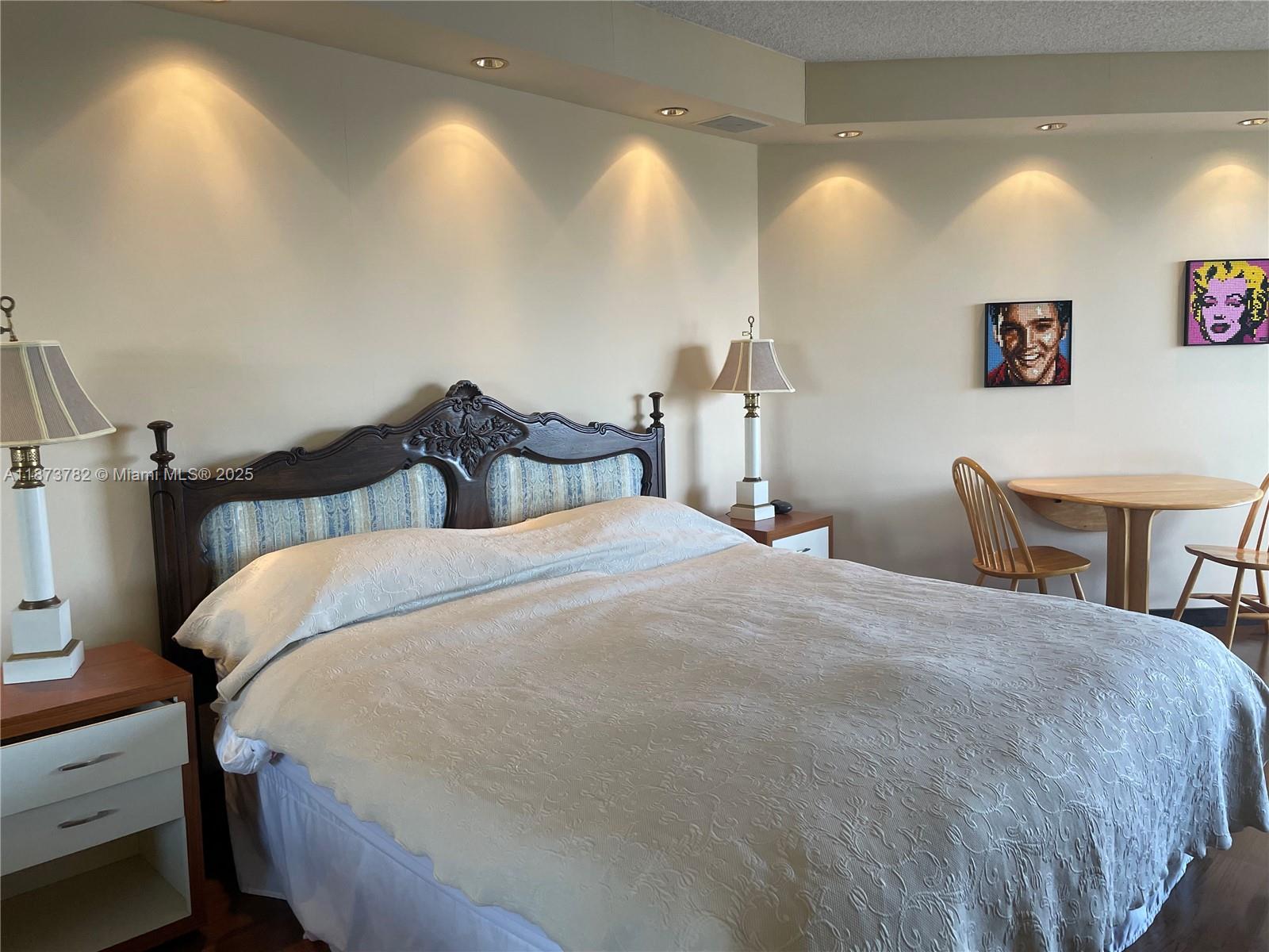 3000 Island Boulevard, Unit 2405 Aventura, FL 33160 - Photo 16 of 26 a bedroom with a bed and a chandelier
