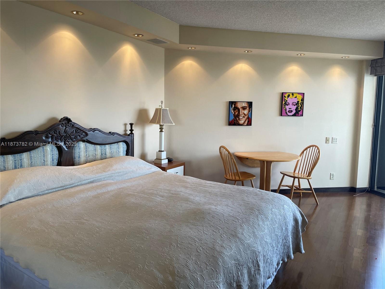 3000 Island Boulevard, Unit 2405 Aventura, FL 33160 - Photo 17 of 26 a bedroom with a bed and a table