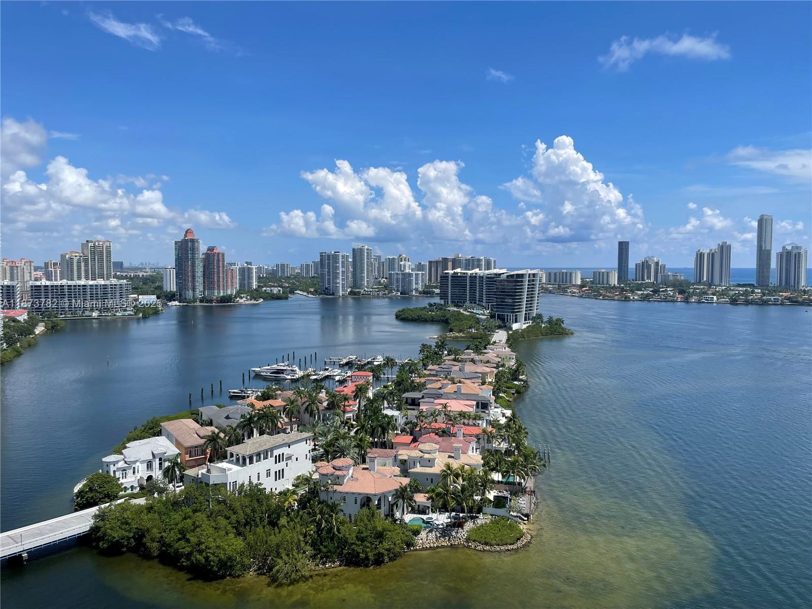 3000 Island Boulevard, Unit 2405 Aventura, FL 33160 - Photo 2 of 26 a view of a lake with a lot of large trees
