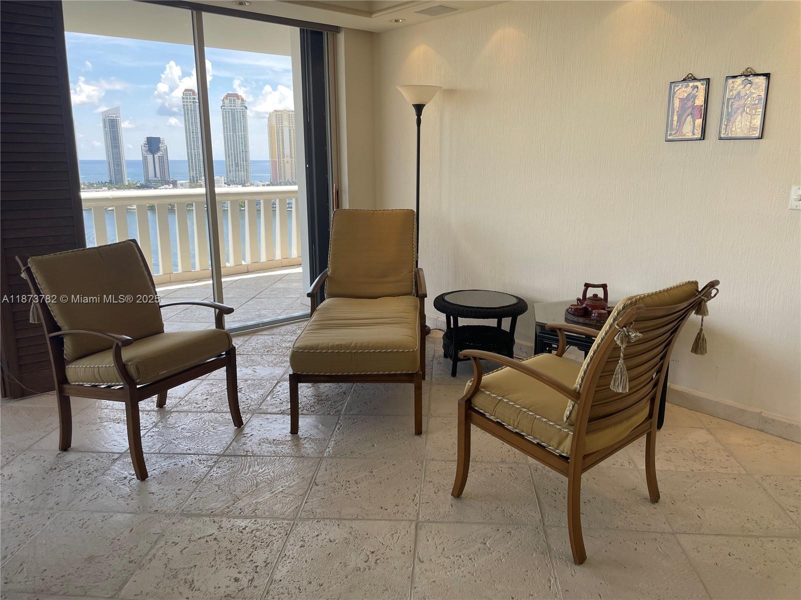3000 Island Boulevard, Unit 2405 Aventura, FL 33160 - Photo 7 of 26 a living room with furniture and a window