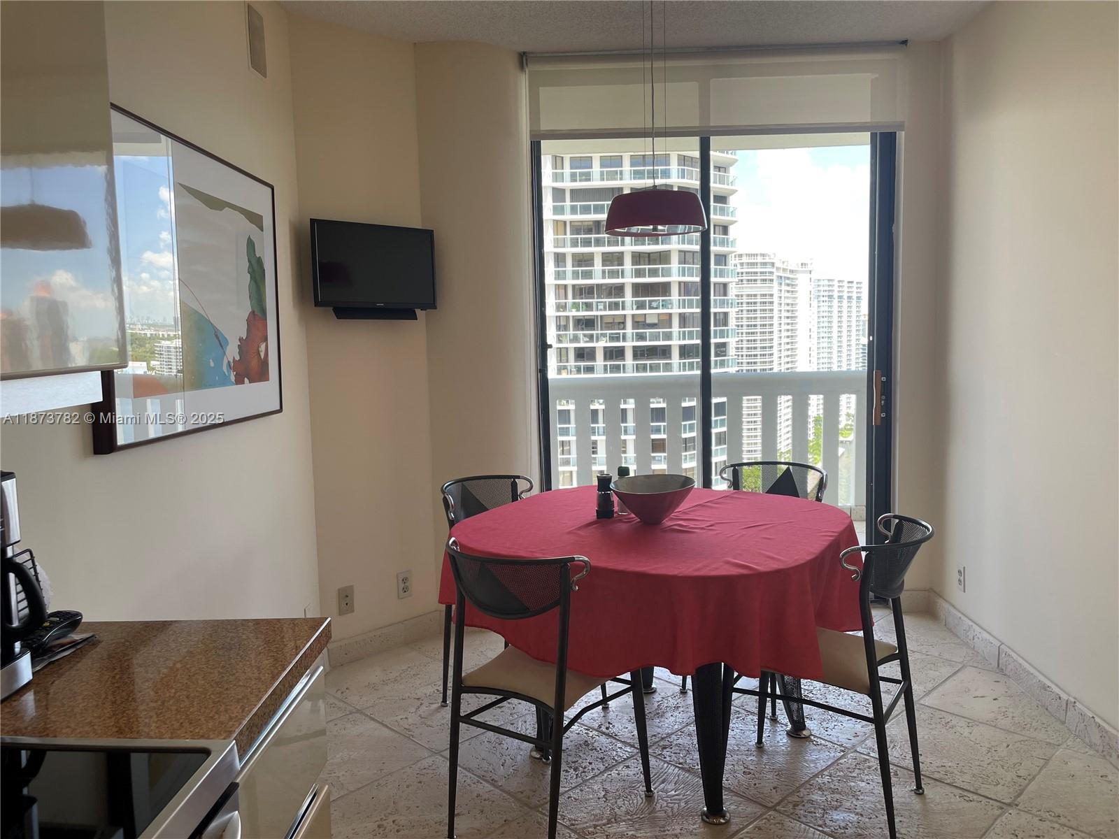 3000 Island Boulevard, Unit 2405 Aventura, FL 33160 - Photo 10 of 26 a dining room with furniture and window