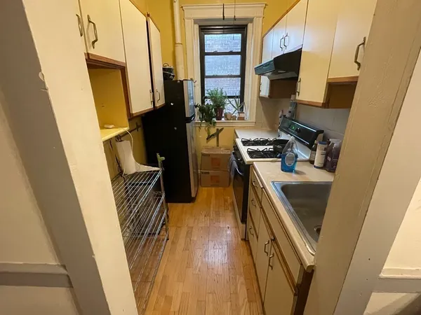 a kitchen with a sink stove and refrigerator