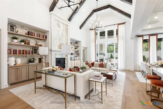 a living room with fireplace furniture and a flat screen tv