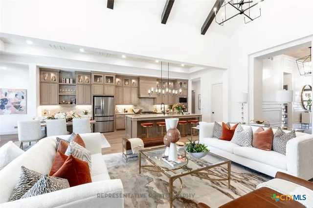 a living room with furniture and view of kitchen