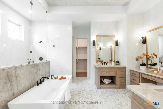 a bathroom with a tub sink and mirror