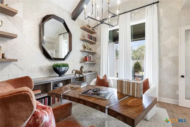 a living room with furniture a large window and a table