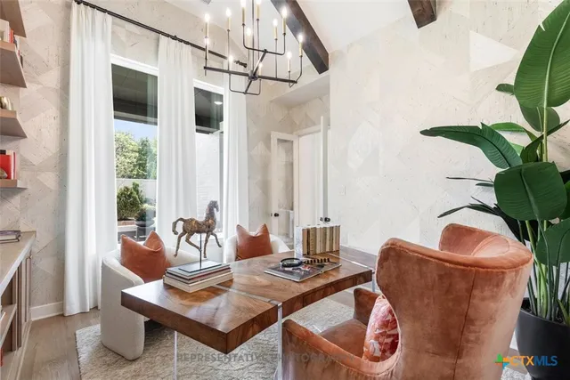 a living room with furniture potted plant and a window