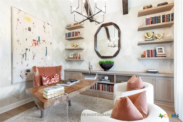 a living room with furniture and a wall painting