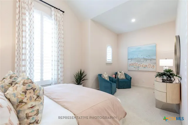 a bedroom with a bed mirror and window
