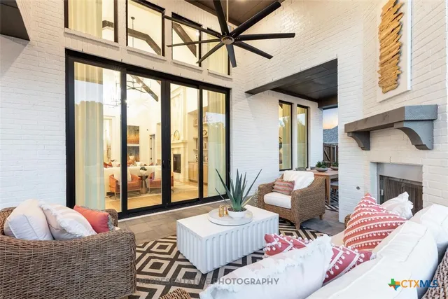 a living room with furniture and a floor to ceiling window