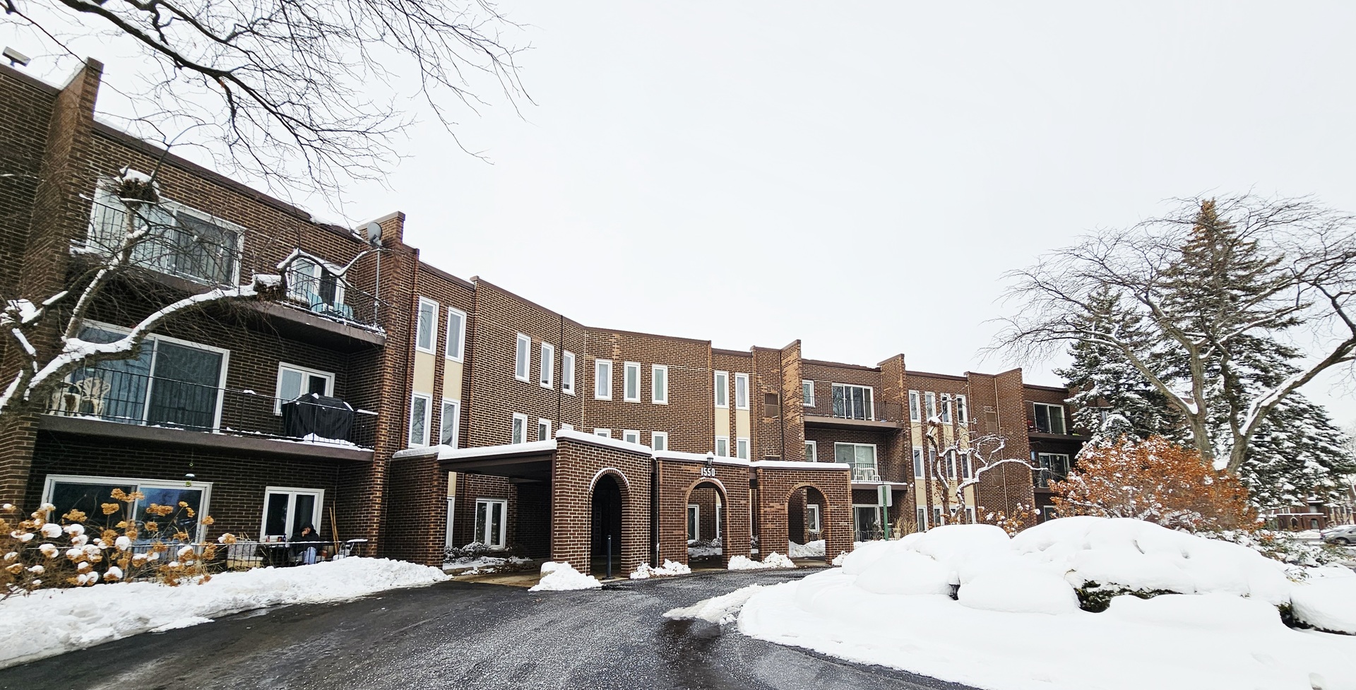 1550 Sandpebble Drive, Unit 210 Wheeling, IL 60090 - Photo 1 of 22 a view of a building with a street