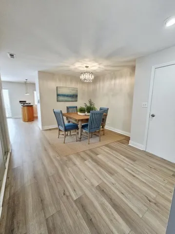 a view of a dining room with furniture and chandelier