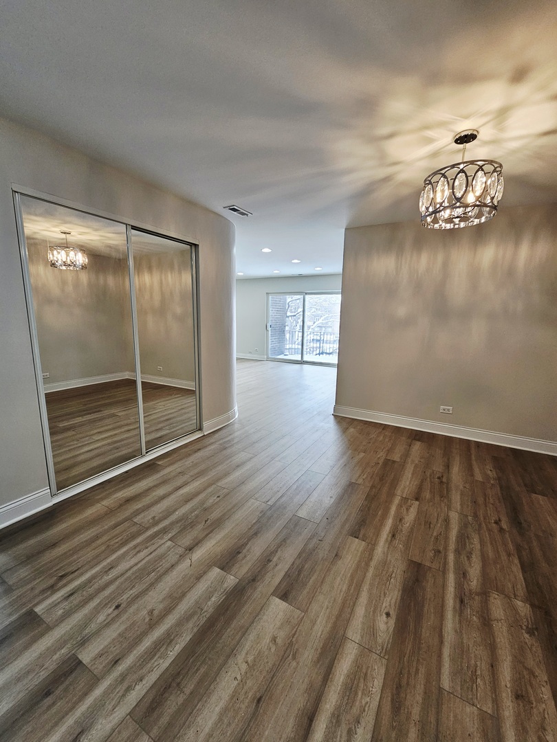 1550 Sandpebble Drive, Unit 210 Wheeling, IL 60090 - Photo 13 of 22 a view of an empty room with wooden floor