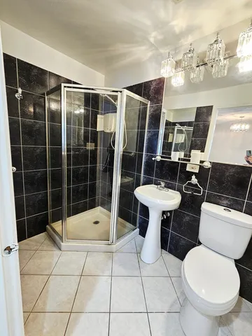 a bathroom with a toilet mirror and tub