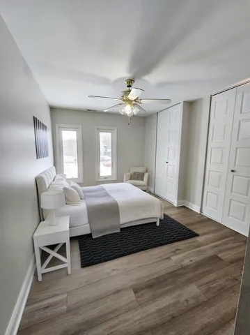 a spacious bedroom with a bed and a chandelier