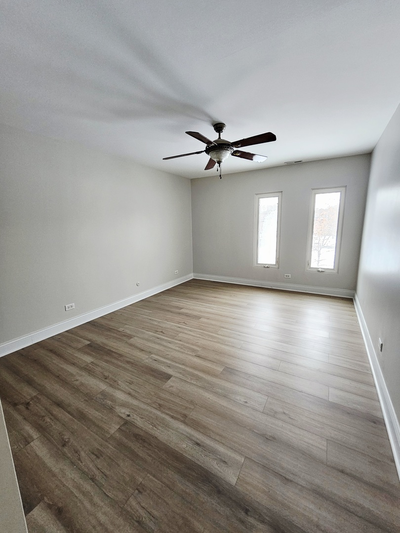 1550 Sandpebble Drive, Unit 210 Wheeling, IL 60090 - Photo 19 of 22 wooden floor in an empty room with a window