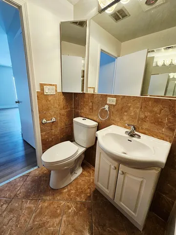 a bathroom with a sink a toilet and mirror