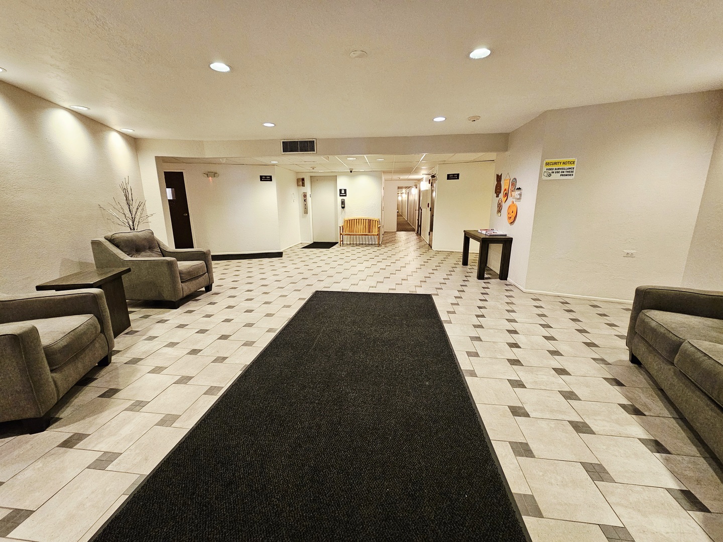 1550 Sandpebble Drive, Unit 210 Wheeling, IL 60090 - Photo 2 of 22 a living room with a couch and a rug