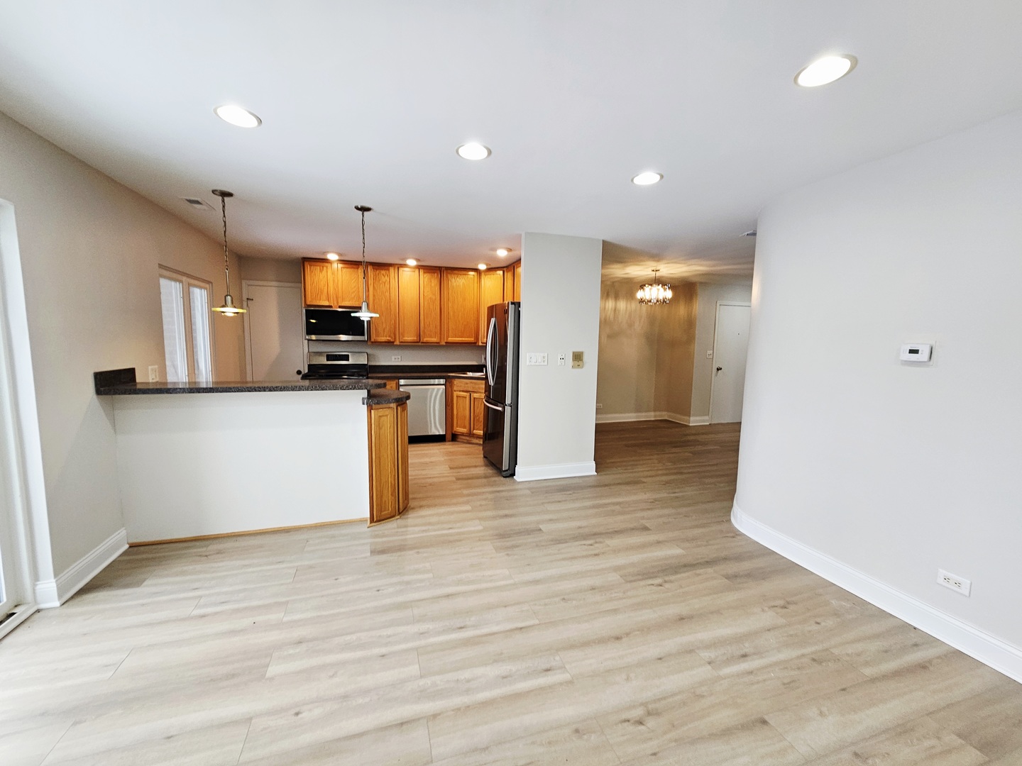 1550 Sandpebble Drive, Unit 210 Wheeling, IL 60090 - Photo 7 of 22 a view of empty room with wooden floor and furniture