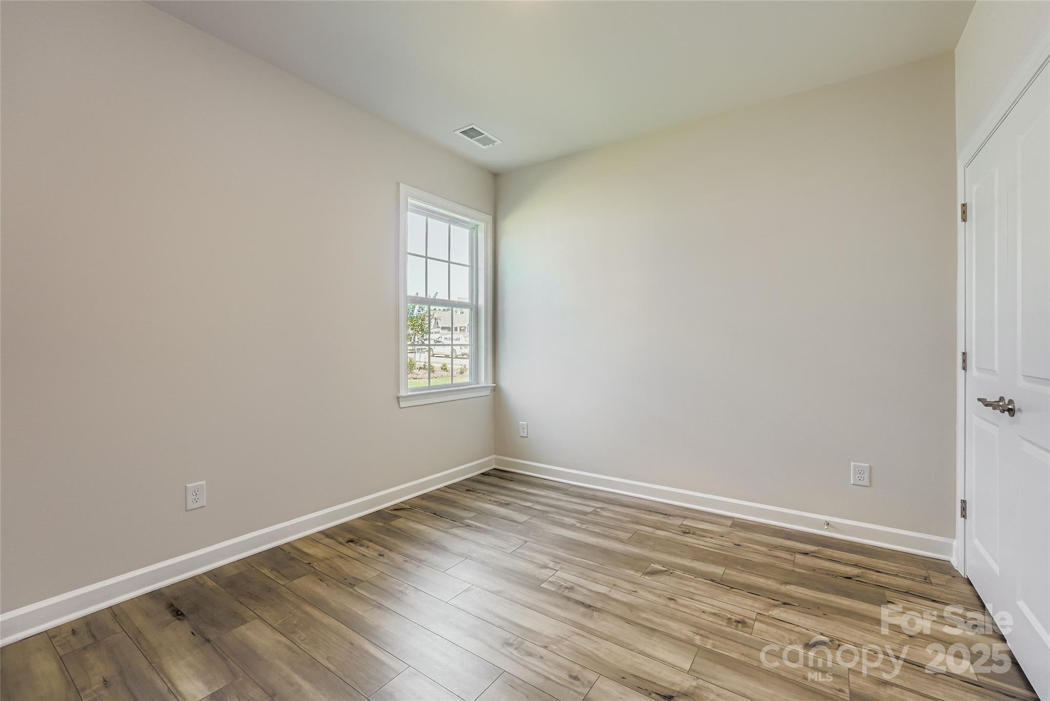 2267 Moon Crst Road Lancaster, SC 29720 - Photo 11 of 17 an empty room with wooden floor and windows