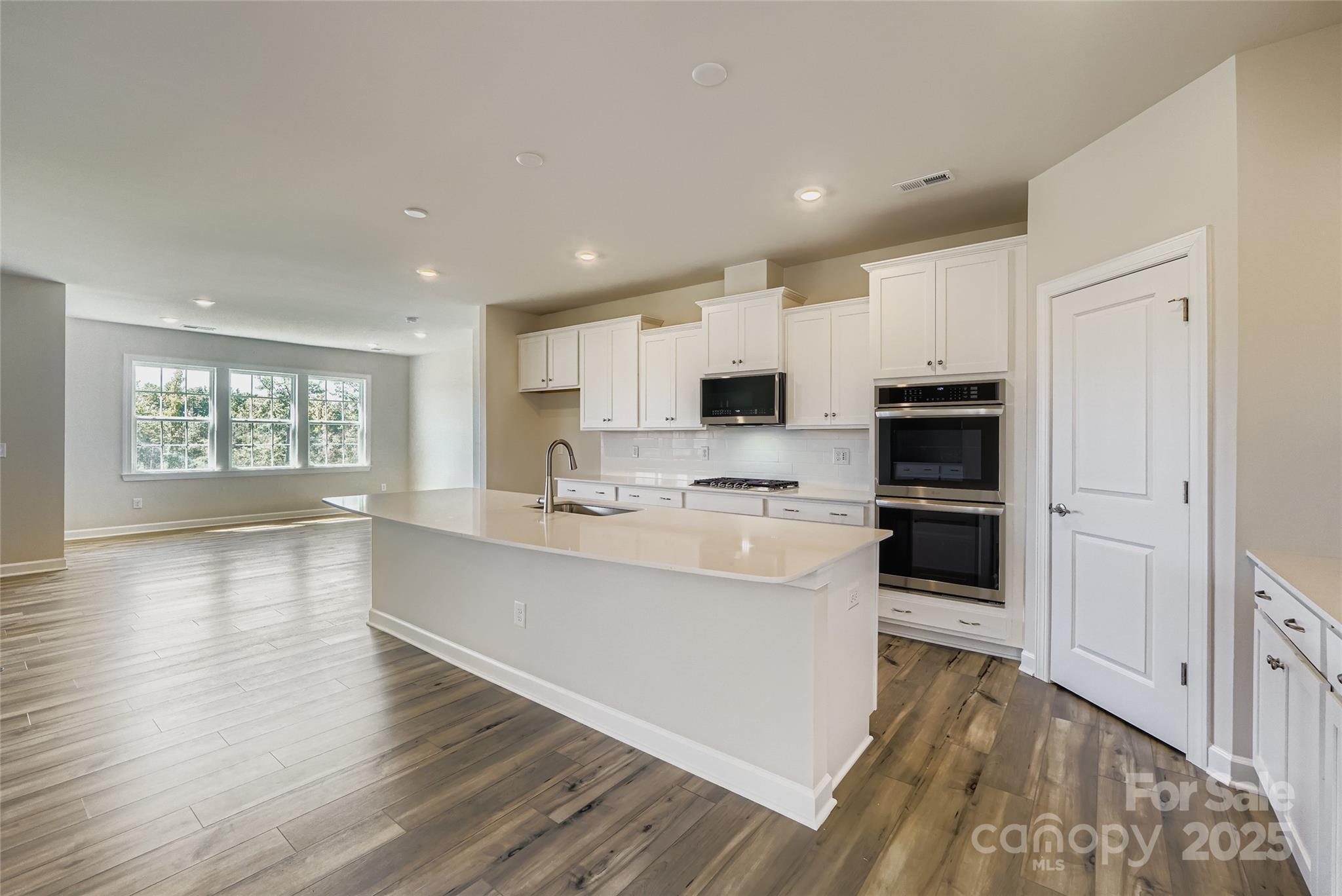 2267 Moon Crst Road Lancaster, SC 29720 - Photo 5 of 17 a kitchen with stainless steel appliances white cabinets a sink a stove a refrigerator and a microwave