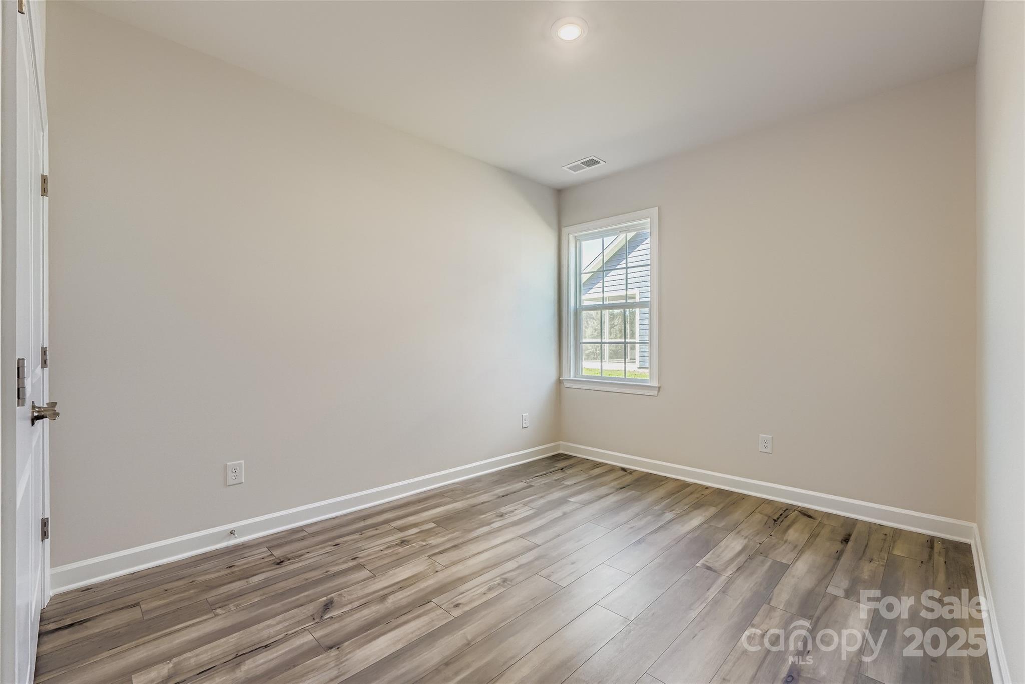 2267 Moon Crst Road Lancaster, SC 29720 - Photo 9 of 17 an empty room with wooden floor and windows