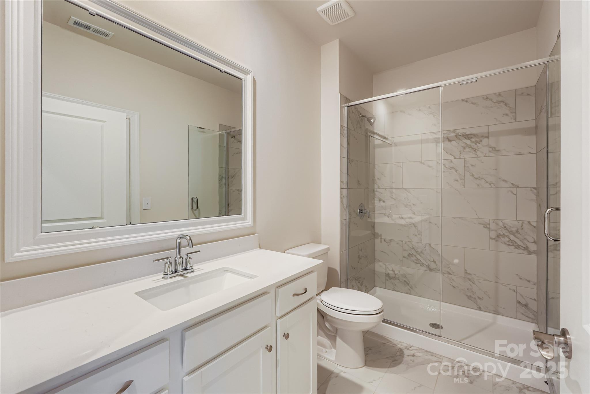 2267 Moon Crst Road Lancaster, SC 29720 - Photo 10 of 17 a bathroom with a sink toilet a mirror and shower