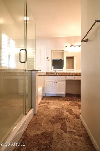 a kitchen with stainless steel appliances granite countertop a sink and a refrigerator