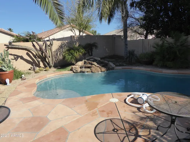 a view of a swimming pool with a yard