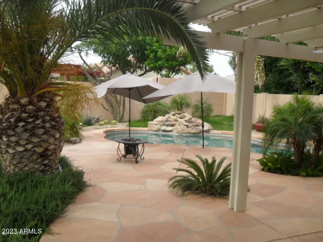 a view of a patio with a table and chairs