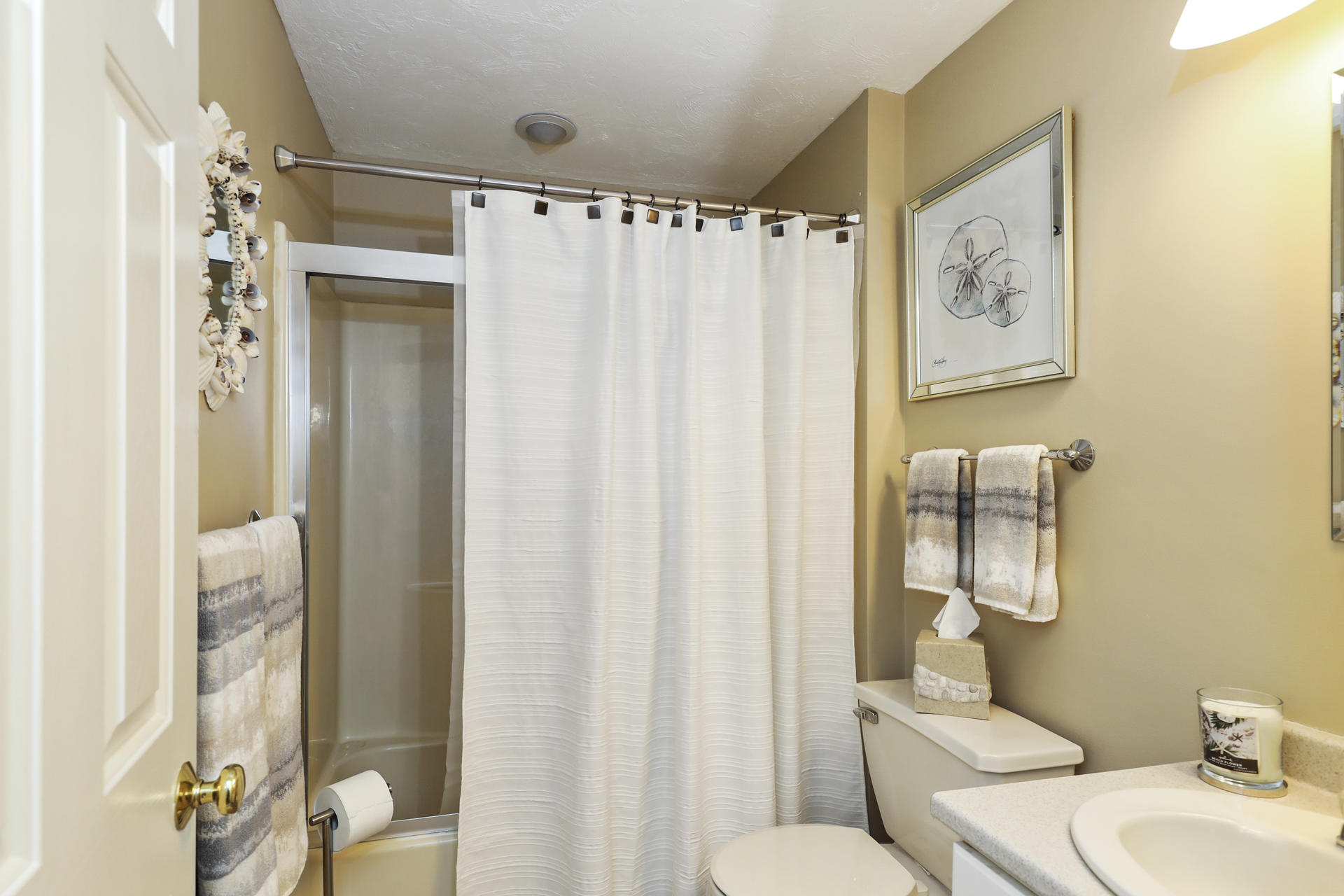 21 Portside Drive Mashpee, MA 02649 - Photo 14 of 20 a bathroom with a sink toilet and shower curtain