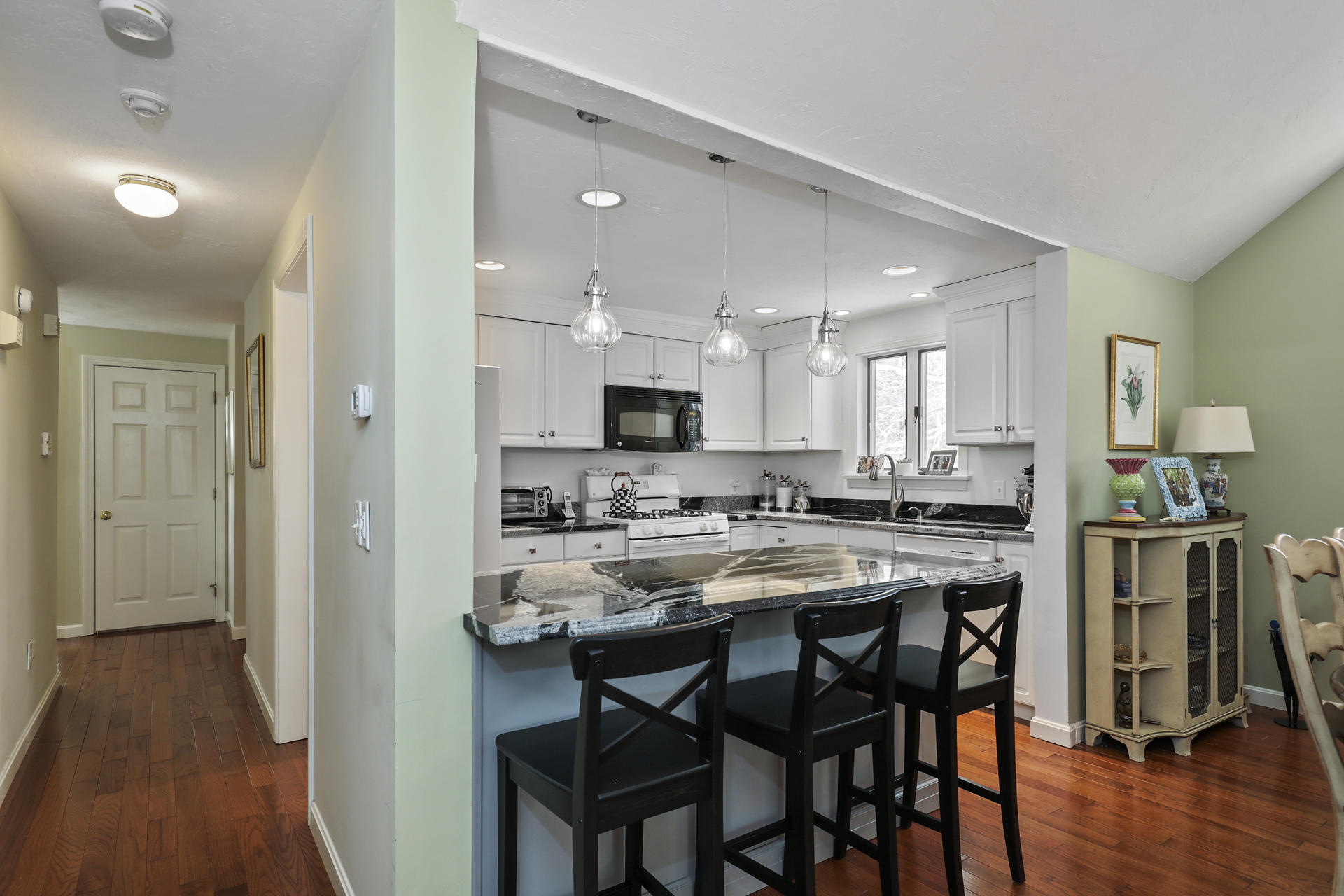 21 Portside Drive Mashpee, MA 02649 - Photo 2 of 20 a view of kitchen with kitchen island dining table and chairs