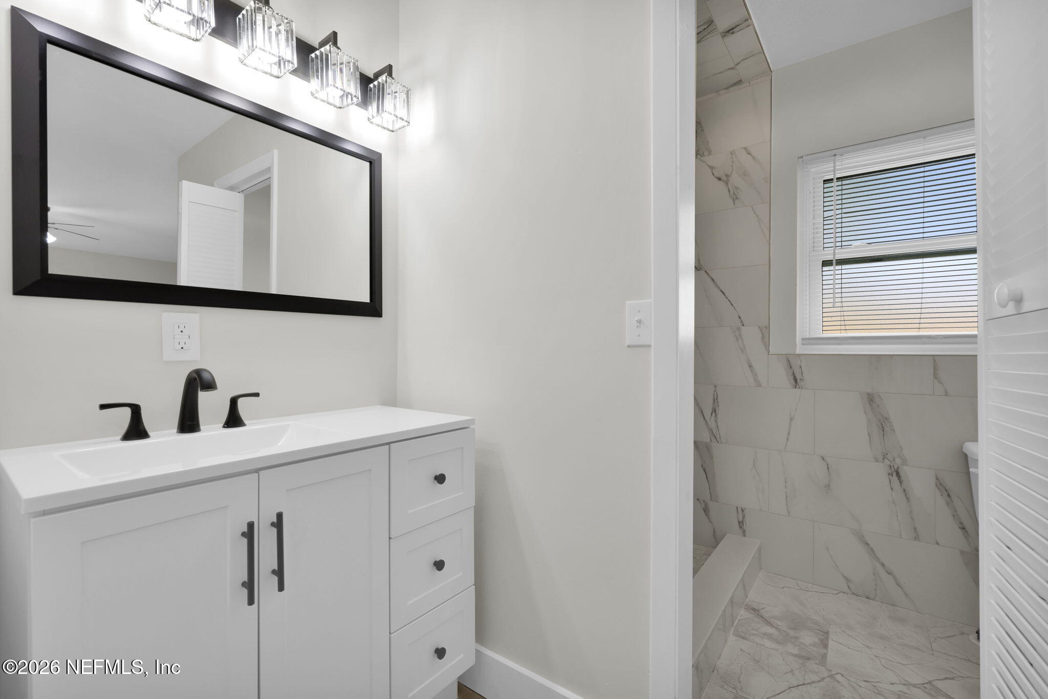 8544 Sanchez Road Jacksonville, FL 32217 - Photo 37 of 46 a bathroom with a sink vanity and a mirror