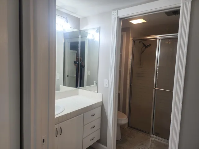 a bathroom with a shower and a sink